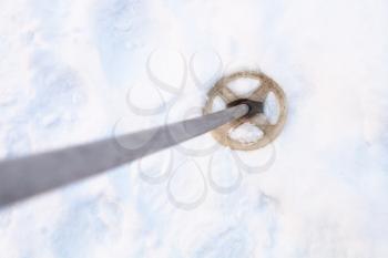 top view of the old ski pole in snowy field in winter twilight
