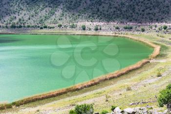 Travel to Turkey - green water of Narligol volcanic Lake (Lake Nar) in Geothermal Field in Aksaray Province of Cappadocia in spring