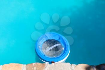 plastic water filter near wall of outdoor swimming pool in summer day