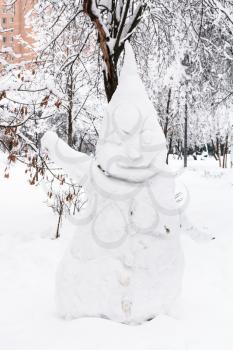 snowman in public urban park in Moscow city in winter snowfall