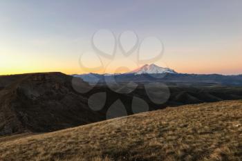travel to North Caucasus region region - view of Mount Elbrus from Bermamyt mountain Plateau at autumn dawn