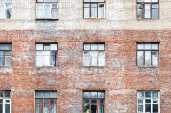 front view of shabby wall of old multistorey brick house in Moscow city