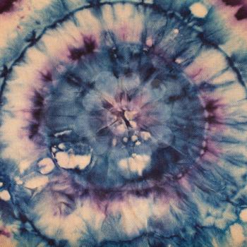 textile background - abstract blue and purple concentric circles hand-painted on silk in tie-dye batik technique