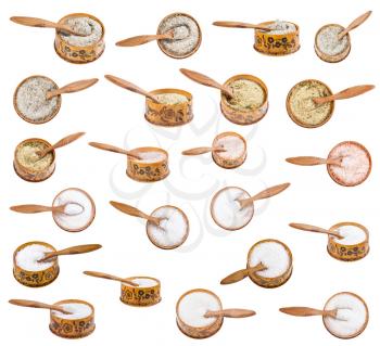 set of wooden salt cellar with little spoon with various salts isolated on white background