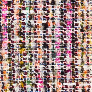 textile square background - colorful woven yarns of boucle fabric close up