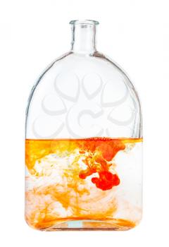orange watercolors dissolving in water in glass flask isolated on white background