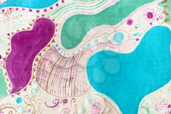 textile background - detail of blue, green and purple handpainted silk scarf with abstract pattern