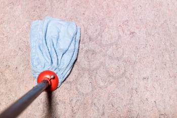 point of view of mop is wiping linoleum floor at home