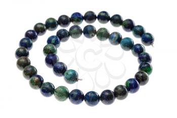 spiral string of beads from natural azurite gems isolated on white background