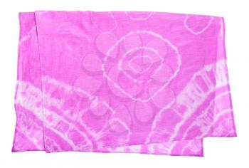 folded pink scarf with abstract pattern colored in tie-dye batik technique isolated on white background