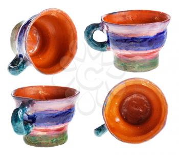 set from handmade and handpainted cups from red clay isolated on white background