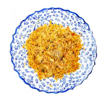 Indian cuisine - top view of portion of Chicken biryani (mixed rice dish made with Indian spices, curry, rice, chicken meat, vegetables) on muslim ornamental plate isolated on white background