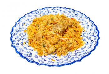 Indian cuisine - portion of Chicken biryani (mixed rice dish made with Indian spices, curry, rice, chicken meat, vegetables) on muslim ornamental plate isolated on white background