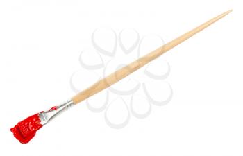 flat paint brush with red colored tip in blot and long wooden handle isolated on white background