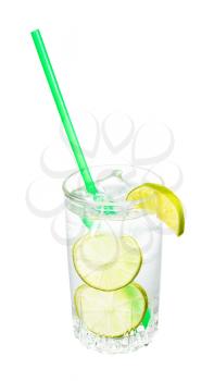 gin and tonic cocktail in glass with wedge and slices of lime, ice and green plastic straw isolated on white background