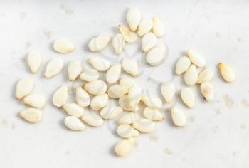 several white sesame seeds close up on gray ceramic plate