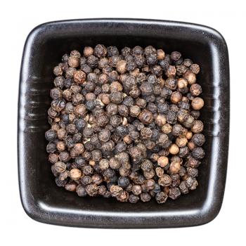 top view of black pepper peppercorns in black bowl isolated on white background