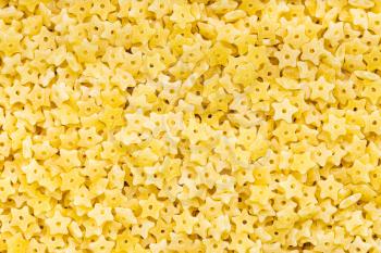 food background - uncooked dry stelline pastina