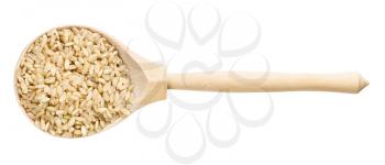 top view of wood spoon with unpolished brown rice grains isolated on white background