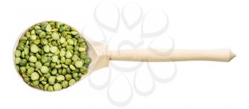 top view of wood spoon with green split peas isolated on white background
