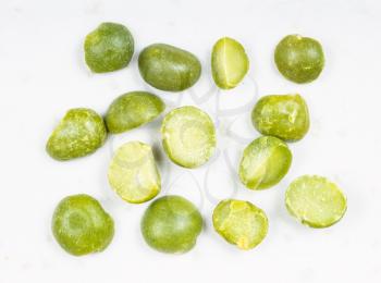 several raw dried green split peas close up on gray ceramic plate