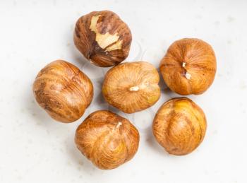 several shelled hazelnuts close up on gray ceramic plate