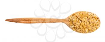 top view of wood spoon with golden flax seeds isolated on white background