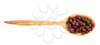 top view of wood spoon with dried schisandra fruits isolated on white background