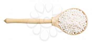 top view of dry sabudana (tapioca sago) in wood spoon isolated on white background