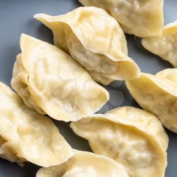 top view of boiled dumplings on gray plate close up