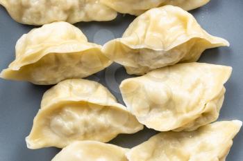 top view of cooked dumplings on gray plate close up