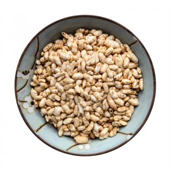top view of puffed brown rice in ceramic bowl isolated on white background