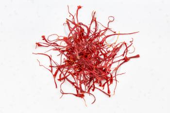 top view of pile of crocus saffron threads close up on gray ceramic plate