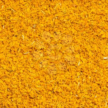 square food background - ground dried tagetes (imeretian saffron) close up