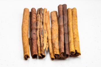 lot of sticks of cassia cinnamon close up on gray ceramic plate