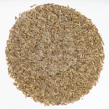 top view of pile of kala zeera (Elwendia persica) seeds on gray ceramic plate