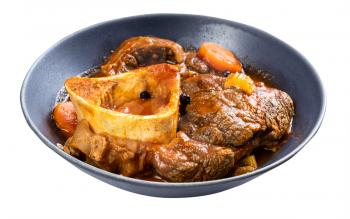 portion of osso buco (beef shin braised with vegetables, wine and broth) in gray bowl isolated on white background