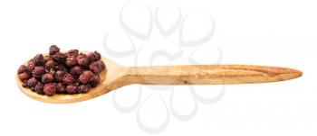 wooden spoon with dried schisandra fruits isolated on white background
