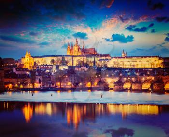 Vintage retro hipster style travel image of Prague Europe concept background - view of Charles Bridge and Prague Castle in twilight. Prague, Czech Republic