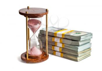 Time is money loan concept background - hourglass and stack of new 100 US dollars 2013 edition banknotes bills bundles isolated on white