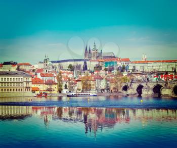 Vintage retro hipster style travel image of Charles bridge over Vltava river and Gradchany (Prague Castle) and St. Vitus Cathedral