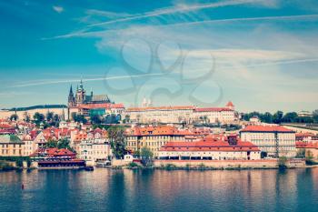 Vintage retro hipster style travel image of Charles bridge over Vltava river and Gradchany (Prague Castle) and St. Vitus Cathedral
