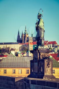 Vintage retro hipster style travel image of John of Nepomuk (or John Nepomucene) national saint of the Czech Republic statue on Charles Brigde at the site where the saint was thrown into Vltava with S