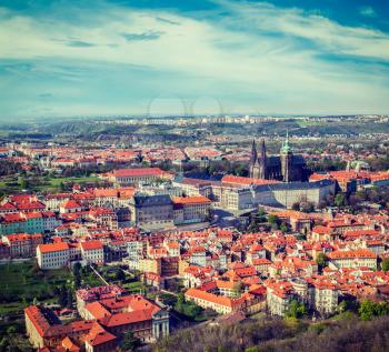 Vintage retro hipster style travel image of aerial view of Hradchany part of Prague: the Saint Vitus (St. Vitt's) Cathedral and Prague Castle, view from Petrin Observation Tower. Prague, Czech Republi