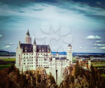 Vintage retro hipster style travel image of Famous Bavarian landmark - Neuschwanstein Castle (Schloss Neuschwanstein). Bavaria, Germany