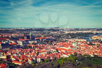 Vintage retro hipster style travel image of aerial view of Hradchany part of Prague the Saint Vitus St. Vitt's Cathedral and Prague Castle, view from Petrin Observation Tower. Prague, Czech Republic