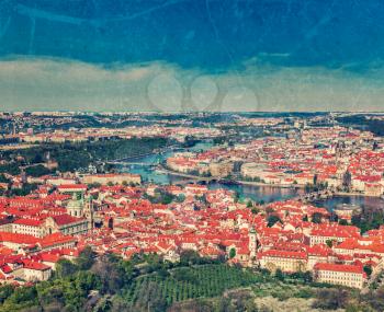 Vintage retro hipster style travel image of aerial view of Charles Bridge over Vltava river and Old city from Petrin hill Observation Tower with grunge texture overlaid. Prague, Czech Republic