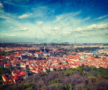 Vintage retro hipster style travel image of aerial view of Hradchany part of Prague: the Saint Vitus (St. Vitt's) Cathedral and Prague Castle, view from Petrin Observation Tower with grunge texture ov