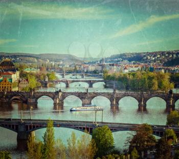 Vintage retro hipster style travel image of travel Prague concept background - elevated view of bridges over Vltava river from Letna Park. Prague, Czech Republic with grunge texture overlaid
