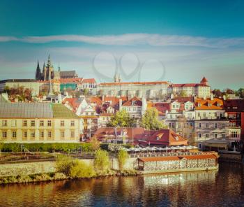 Vintage retro hipster style travel image of Mala Strana and  Prague castle over Vltava river. Prague, Czech Republic
